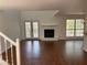 Bright living room with fireplace, French doors, and hardwood floors offers a cozy ambiance at 705 Bridge Se Ln, Smyrna, GA 30082