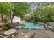 Community pool with various seating, surrounded by mature trees and landscaping at 705 Bridge Se Ln, Smyrna, GA 30082