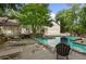 Community pool with various seating, surrounded by mature trees and landscaping at 705 Bridge Se Ln, Smyrna, GA 30082