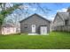 Spacious backyard with lush green grass, white shed, and a newly built home addition at 1147 Oakland Sw Dr, Atlanta, GA 30310