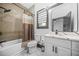 Bathroom featuring a shower/tub combination, modern fixtures, marble countertop, and stylish vanity with ample storage at 1147 Oakland Sw Dr, Atlanta, GA 30310