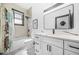 Bright bathroom features a shower/tub combination, marble countertop, and a modern rectangular mirror with accent lighting at 1147 Oakland Sw Dr, Atlanta, GA 30310