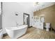 Modern bathroom featuring a freestanding tub, double vanity, and wood-look tile floors at 1147 Oakland Sw Dr, Atlanta, GA 30310