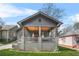 Inviting front porch with wood ceiling, swing, and brick foundation at 1147 Oakland Sw Dr, Atlanta, GA 30310