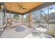 Relaxing front porch with wood ceiling, fan, swing, chair, and neighborhood view at 1147 Oakland Sw Dr, Atlanta, GA 30310