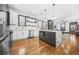 Modern kitchen featuring stainless steel appliances, waterfall island, and sleek white cabinetry at 1147 Oakland Sw Dr, Atlanta, GA 30310