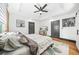 Bright main bedroom with tray ceiling, ceiling fan, hardwood floors, and ensuite bathroom at 1147 Oakland Sw Dr, Atlanta, GA 30310