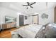 Bright main bedroom featuring tray ceiling, ceiling fan, hardwood floors, and access to ensuite bathroom at 1147 Oakland Sw Dr, Atlanta, GA 30310