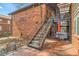 Brick apartment building with a metal staircase leading to upper-level balconies and tiled patio at 1284 Piedmont Ne Ave # 12, Atlanta, GA 30309