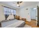 Comfortable bedroom with hardwood floors, a window with curtains, and an open closet at 1284 Piedmont Ne Ave # 12, Atlanta, GA 30309