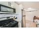 A view of the kitchen with stainless steel appliances and white shaker cabinets at 1284 Piedmont Ne Ave # 12, Atlanta, GA 30309