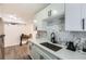 Modern kitchen features white cabinets, white countertops and marble backsplash adding a touch of elegance at 1284 Piedmont Ne Ave # 12, Atlanta, GA 30309