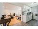 Modern kitchen and living room featuring white cabinets and stainless steel appliances at 1284 Piedmont Ne Ave # 12, Atlanta, GA 30309