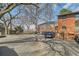 Brick apartment building with a gravel parking lot and mature trees overhead at 1284 Piedmont Ne Ave # 12, Atlanta, GA 30309