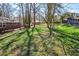 Spacious backyard featuring a wooden deck with brick house and a mix of trees and grassy areas at 2780 Eastfield Se Rd, Smyrna, GA 30080