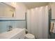 Bathroom with blue tile, updated vanity, and a white shower curtain at 2780 Eastfield Se Rd, Smyrna, GA 30080