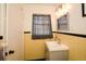 Traditional bathroom with yellow and black tile, white sink, mirror, and vanity lights at 2780 Eastfield Se Rd, Smyrna, GA 30080