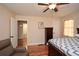 Bedroom with hardwood floors, a ceiling fan, and a peek into the bathroom at 2780 Eastfield Se Rd, Smyrna, GA 30080