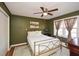 Cozy bedroom with wood paneling, a ceiling fan, and a large window at 2780 Eastfield Se Rd, Smyrna, GA 30080