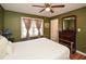 Charming bedroom with wood floors, ceiling fan, dresser, and a large window at 2780 Eastfield Se Rd, Smyrna, GA 30080