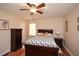 Bedroom with hardwood floors, queen size bed with patterned comforter, and a ceiling fan at 2780 Eastfield Se Rd, Smyrna, GA 30080