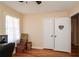 Bedroom features hardwood floors, a closet, and a window with sheer curtains, providing a comfortable living space at 2780 Eastfield Se Rd, Smyrna, GA 30080