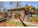 Brick house exterior with front steps, an American flag, and a small wooden deck at the back at 2780 Eastfield Se Rd, Smyrna, GA 30080