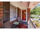 Cozy front porch with brick facade, seating, and a view of the outdoors at 2780 Eastfield Se Rd, Smyrna, GA 30080