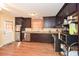 Spacious kitchen with dark wood cabinets, stainless steel appliances, and hardwood floors at 2780 Eastfield Se Rd, Smyrna, GA 30080