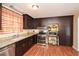 Kitchen featuring stainless steel appliances, granite countertops, and dark wood cabinets at 2780 Eastfield Se Rd, Smyrna, GA 30080