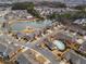 Aerial view of a residential neighborhood with a community pond and pool at 348 Lauren Ln, Woodstock, GA 30188