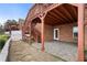 Backyard patio area features a brick wall, paver patio, access to the elevated wooden deck with stairs at 348 Lauren Ln, Woodstock, GA 30188