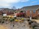 Red brick home featuring a spacious backyard with a deck and patio, set against a landscaped hillside at 348 Lauren Ln, Woodstock, GA 30188