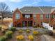 Brick townhome with a raised deck and patio overlooking a landscaped backyard at 348 Lauren Ln, Woodstock, GA 30188