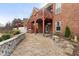 Charming brick home featuring a spacious wooden deck, stone retaining wall, and well-maintained landscaping at 348 Lauren Ln, Woodstock, GA 30188