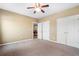 Neutral bedroom featuring carpet, ceiling fan, and closet space at 348 Lauren Ln, Woodstock, GA 30188