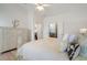 Bright bedroom featuring light hardwood floors, a ceiling fan, and decoratively designed furnishings at 348 Lauren Ln, Woodstock, GA 30188