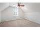 A bedroom with off-white walls, light tan carpeting, and a window with interior shutters at 348 Lauren Ln, Woodstock, GA 30188