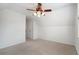 An open bedroom with a ceiling fan and neutral carpeting offers comfort and style at 348 Lauren Ln, Woodstock, GA 30188