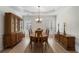 Formal dining room featuring hardwood floors, shuttered windows, and traditional furnishings at 348 Lauren Ln, Woodstock, GA 30188