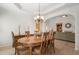 Bright dining room with wood table set, chandelier, and view of living room at 348 Lauren Ln, Woodstock, GA 30188