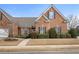 Beautiful brick home featuring manicured landscaping and a symmetrical facade with black shutters at 348 Lauren Ln, Woodstock, GA 30188