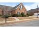 Well-maintained brick home with manicured lawn and mature landscaping at 348 Lauren Ln, Woodstock, GA 30188