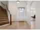 Elegant foyer with hardwood floors, staircase, and transom window above the front door at 348 Lauren Ln, Woodstock, GA 30188