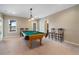 This game room comes with billiard table, bar stools, view and natural light at 348 Lauren Ln, Woodstock, GA 30188