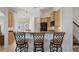 Kitchen bar and seating area with granite countertops and stainless steel appliances and wooden cabinets at 348 Lauren Ln, Woodstock, GA 30188