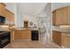 Open kitchen with stainless steel appliances, granite counters, tile backsplash, and hardwood floors at 348 Lauren Ln, Woodstock, GA 30188