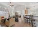 Open-concept living room with bar seating, hardwood floors, and an abundance of natural light at 348 Lauren Ln, Woodstock, GA 30188