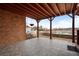 Covered patio with brick exterior overlooking the lake at 348 Lauren Ln, Woodstock, GA 30188