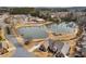 Aerial view shows the scenic community pond, surrounded by lush landscaping and nearby shopping at 348 Lauren Ln, Woodstock, GA 30188